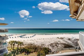 Beachfront condo with beach chairs an umbrella and a pool - 6