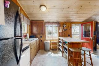 Quiet lakefront cottage with a firepit, private beach, & two kayaks - 1
