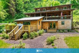 Log cabin w riverfront & hot tub - 0