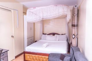 Luxurious City Escape Haven Suite - comfortable living and sleeping space a modern bathroom with a stylish glass shower - 0