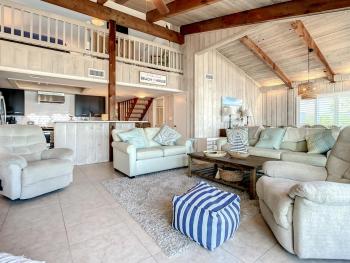 Beachfront Deck with steps down to the white sandy beach Sea Dunes Sandcastle 1A, Edgewater (photo 2)
