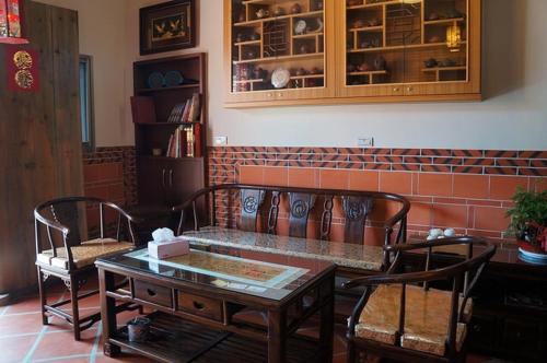 a room with a table, chairs, and a painting on the wall, Teapot House in Kinmen Islands