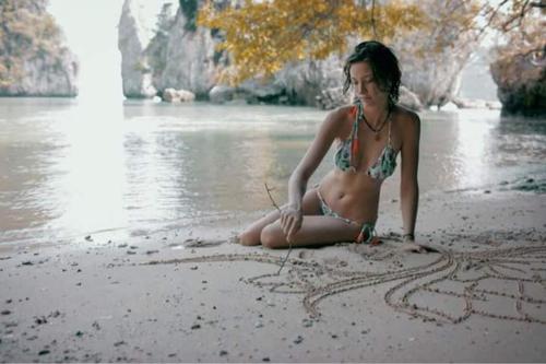 a woman in a bikini sitting on a beach, KRABI BAMBOO KINGDOM at AOLUEK PARADISE in Krabi