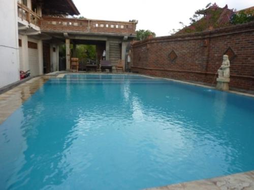 a swimming pool with a pool table and chairs, Mandhara Chico Bungalow in Bali