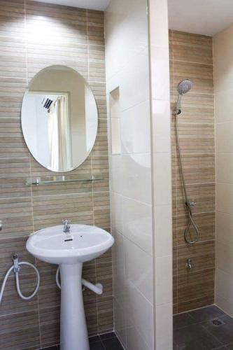 a bathroom with a shower, sink, and mirror, Field Town Apartment in Nakhon Nayok