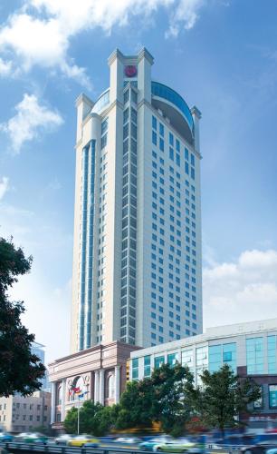 a tall building with a clock on the top of it, Wuhan Ramada Plaza Tian Lu Hotel in Wuhan