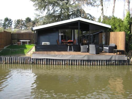 Modern chalet in a small park with a fishing pond