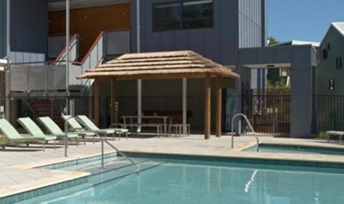 a patio area with chairs and a pool, Footprints Preston Beach in Mandurah