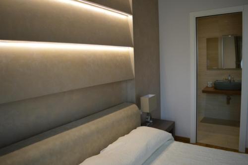 a hotel room with a white bed and white walls, B&B Jolie center in Pescara
