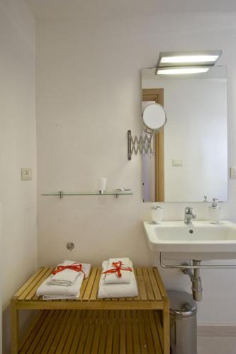 a bathroom with a sink and a towel rack, Vico Amato Residenza in Sulmona