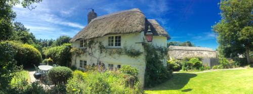 Putsborough Manor 3 Self Catering Cottages with Beach a short walk dog friendly all year, On site Tennis, Play Area, Paddock, Spa baths, BBQ, Private Gardens, Superfast WIFI