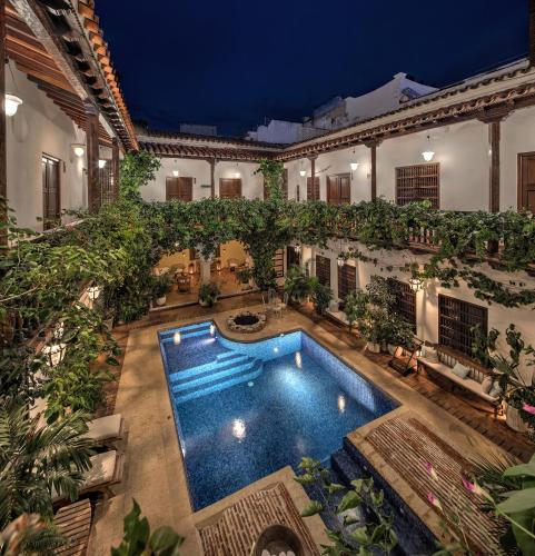 aerial view of a pool surrounded by balconies with ivy at a boutique hotel Cartagena Colombia