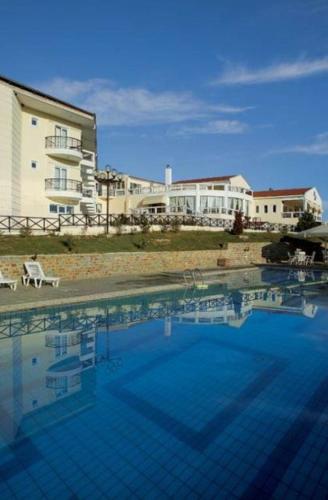 a hotel room with a pool and a blue sky, Hotel Αchillion Grevena in Grevena