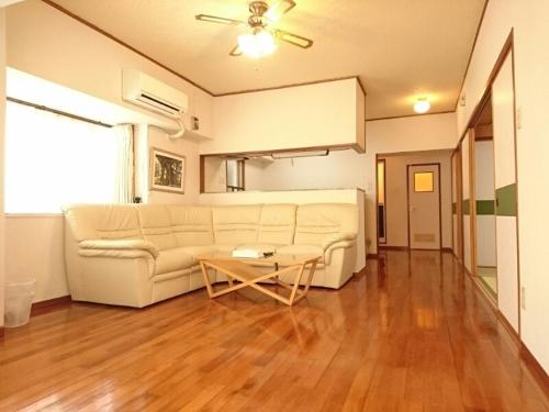 a living room filled with furniture and a couch, Kokusai Towns Inn in Okinawa Main island