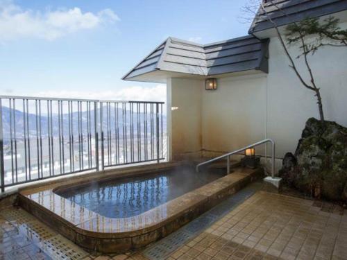 a bathroom with a pool and a large window, Kindayu in Shibukawa
