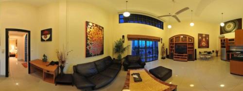 a living room filled with furniture and a large window, Royal Park Apartments in Pattaya