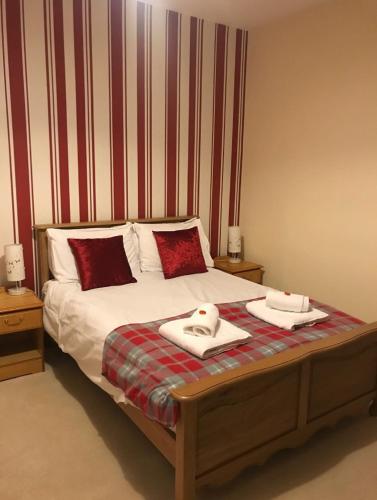 a bed with a white comforter and pillows on it, The Silverfjord Hotel in Kingussie