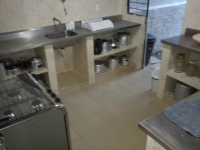 a kitchen with a sink and a stove, Porto de Galinhas Hostel in Porto De Galinhas