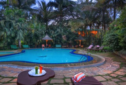 Swimming pool, Hoysala Village Resort in Hassan