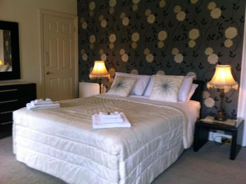 a neatly made bed in a hotel room, Carlingford House Town House Accommodation A91 TY06 in Carlingford