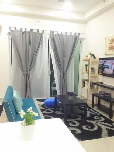a living room filled with furniture and a tv, Julia's Cottage in Kota Bharu