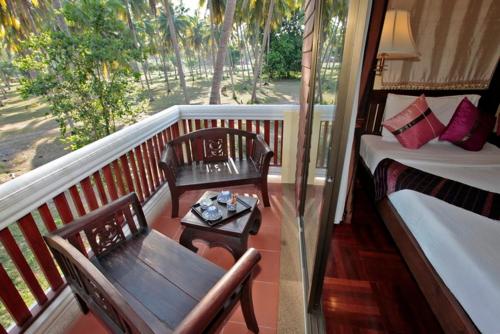 a living room filled with furniture and a balcony, Coral Hotel Bangsaphan in Prachuap Khiri Khan