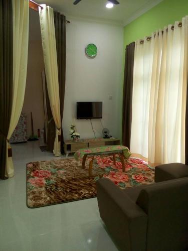 a living room filled with furniture and a fire place, IMAN HOMESTAY & TRANSIT ROOM in Kota Bharu