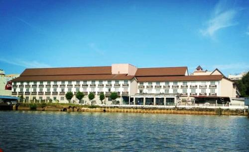 a large building with a large window overlooking a body of water, Hotel Seri Malaysia Kuala Terengganu in Kuala Terengganu