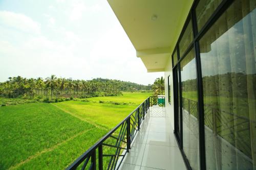 balkon/terras, Paddyfield Inn in Kattikkulam
