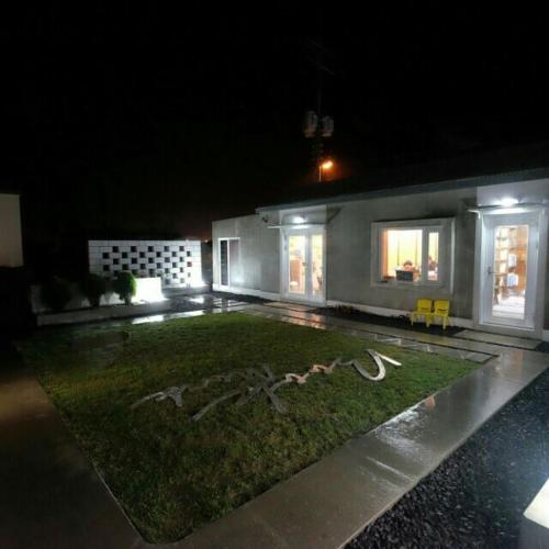 a large white building with a fire hydrant in the middle of it, Bookmark Guesthouse in Jeju
