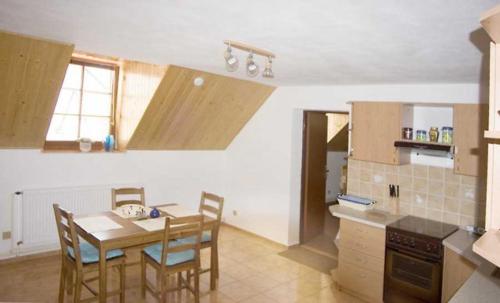 a kitchen with a table and chairs and a stove, Rodinny penzion Kunc in Slavonice