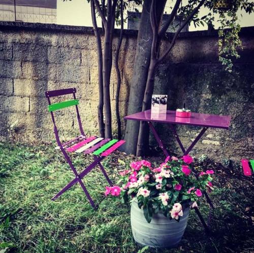 a bench in a garden with flowers in it, B&B Parini in Cassino