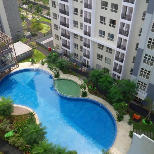 a large swimming pool in a large city, Scientia Residences Gading Serpong Taslim Property in Tangerang