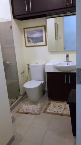 a bathroom with a toilet a sink and a bathtub, Pico De Loro - Myna B Studio in Nasugbu