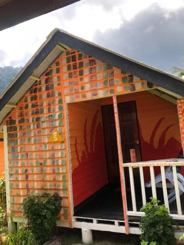 a red brick building with a red door, Beach Shack Chalet - Garden View Aframe Big Unit in Tioman Island