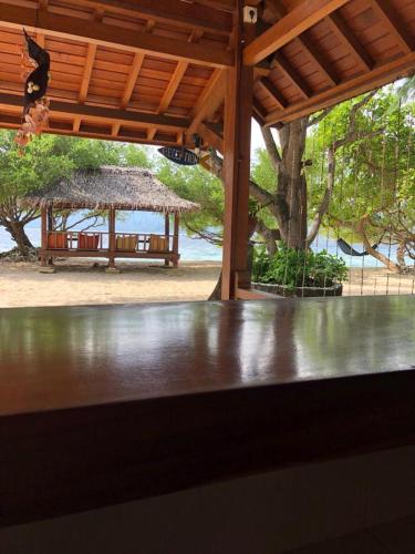 a patio area with a view of the ocean, Birumeno Beach Bungalow in Lombok