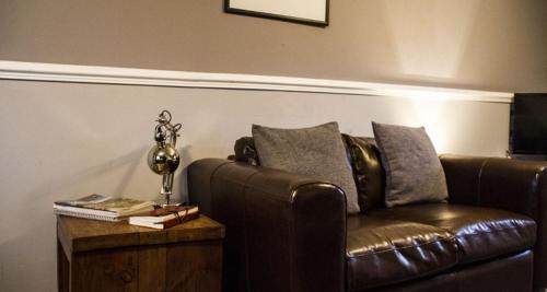 a living room with a couch and a coffee table, Home Farm Apartments in Portree