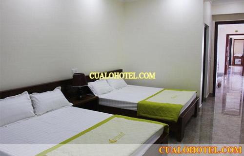 a hotel room with two beds and two lamps, Son Hien Hotel in Cua Lo Beach
