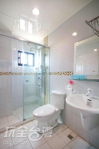 a white toilet sitting in a bathroom next to a sink, Enjoy Summer in Penghu
