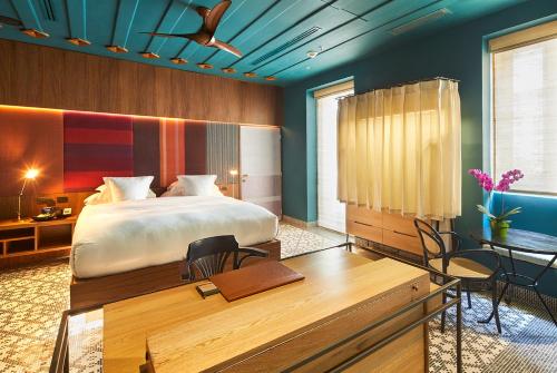 A room with a large bed and colorful walls in a Cartagena, Colombia boutique hotel