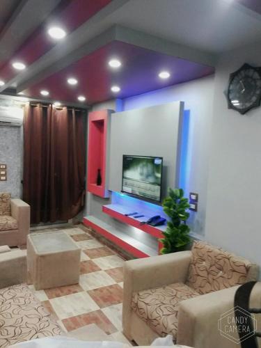 a living room filled with furniture and a tv, North Coast Princess Al Fayrouz in Marsa Matruh