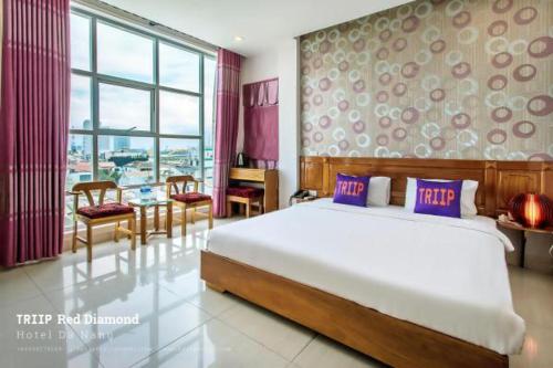 a hotel room with a large bed and a large window, TRIIP Red Diamond Hotel in Da Nang