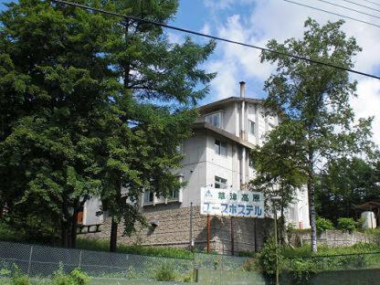 a church with a clock on the front of it, Kusatsu Kogen Youth Hostel in Kusatsu