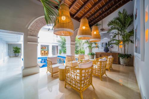chairs under archways in front of a pool at one of the hotels boutique Cartagena