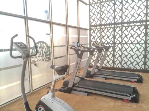 1BR with Extra Balcony The Oasis Cikarang Apartment By Travelio - image 2