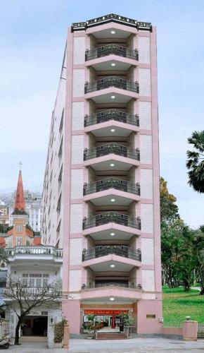 a tall building with a clock on the top of it, Thai Binh 2 Hotel in Hue