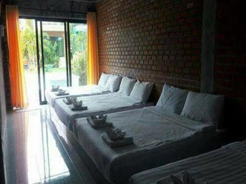 a hotel room with two beds and a window, Irak resort in Prachuap Khiri Khan