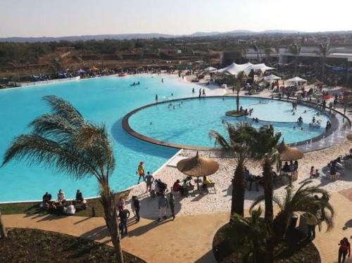 A Coastal/island experience at a Large 2 bed apartment at a Crystal Lagoon Estate.