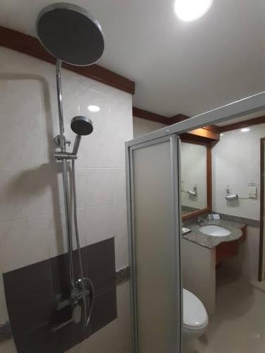 a bathroom with a toilet and a shower stall, SARA HOTEL in Labuan