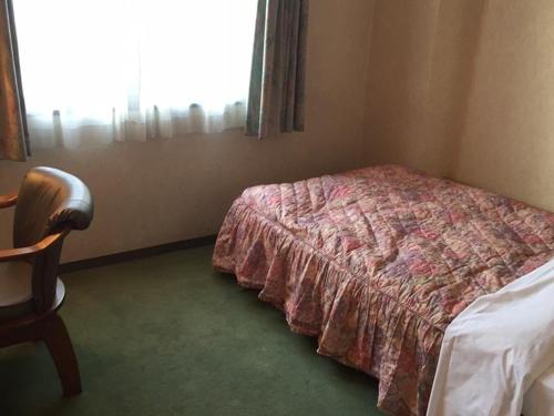 a bedroom with a bed and a window, Business Green Hotel Youkaichi in Higashiomi